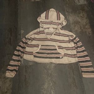 It is a cropped hoodie. It is crème with black and pink stripes